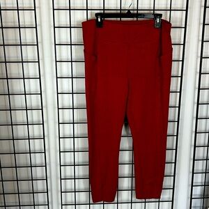 Cabi slim leggings, size large, rust-amber color, side pockets.